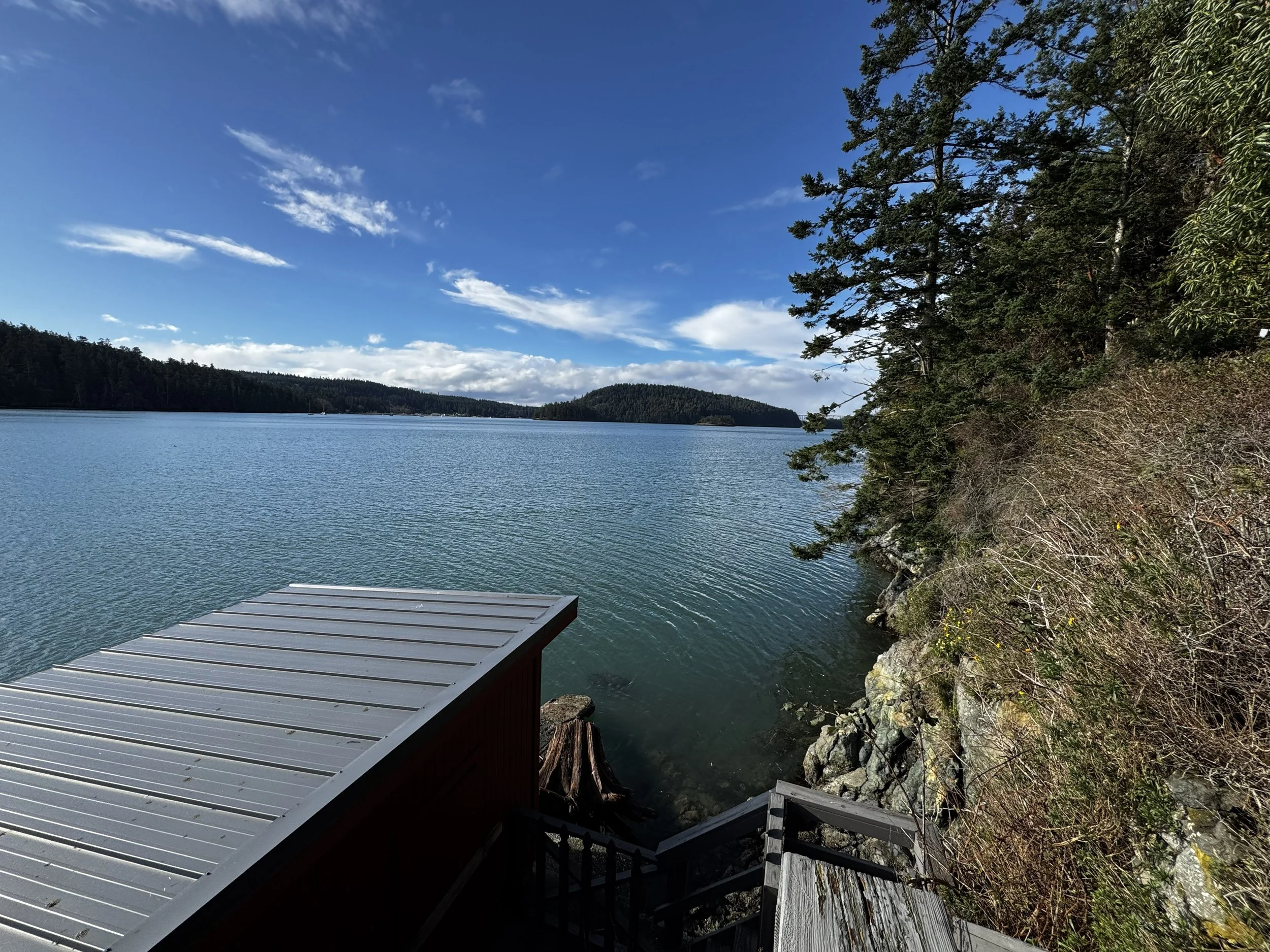The boat house access is to the west.  There is seating inside the boat house with a view facing the Deception Pass Bridge and Whidbey Island. 