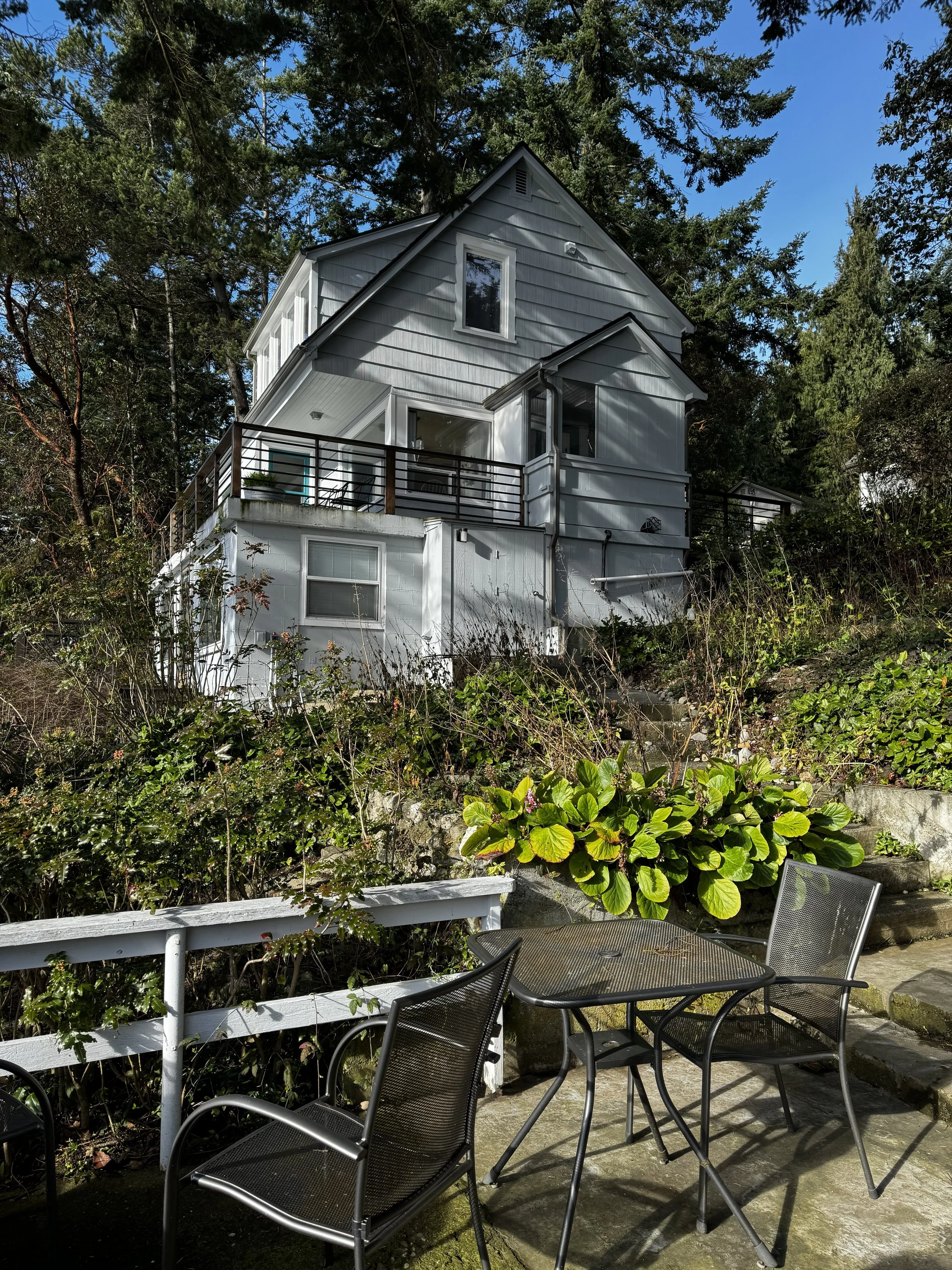 The Sunroom on the basement level, the Windows of the dining nook on the main level and the master bedroom on the upper level share the east elevation.  There is a lower patio with room for a barbeque and seating. 