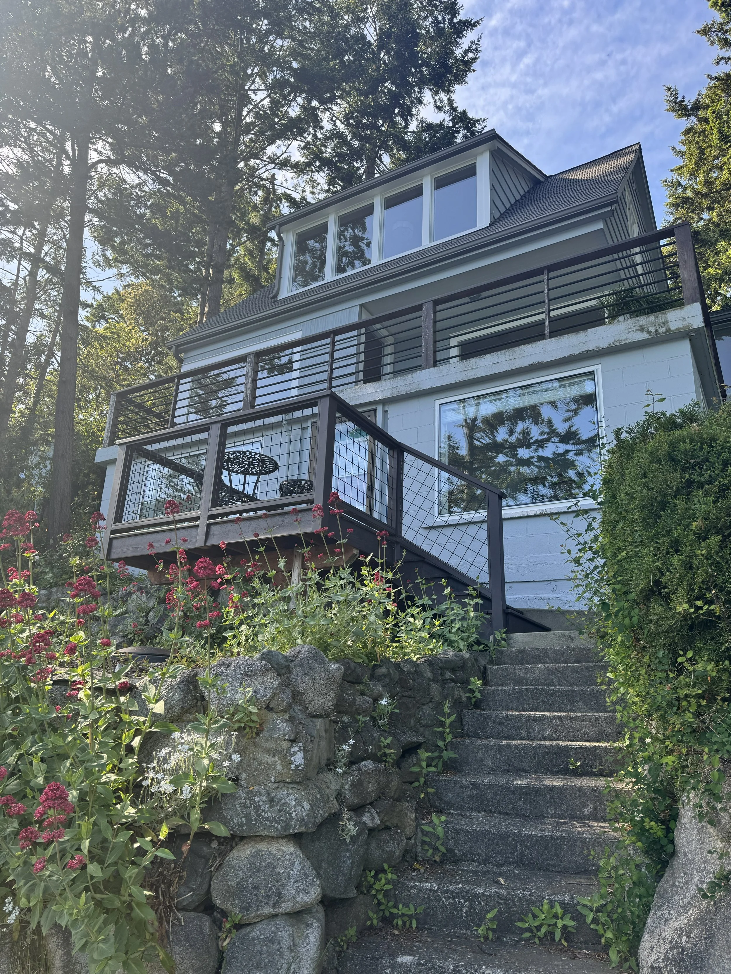 The sunroom on the basement level, the dining nook and living room on the main level and the master bedroom on the upper level share the south elevation. 