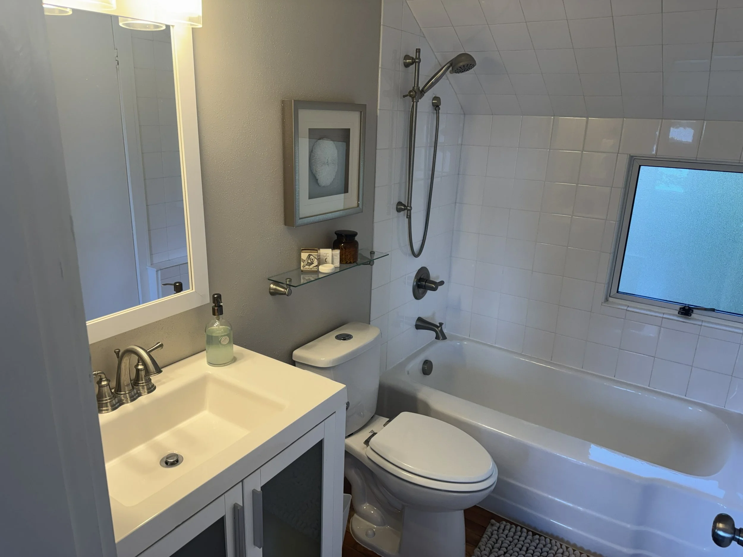 The master bathroom is cozy and charming. 