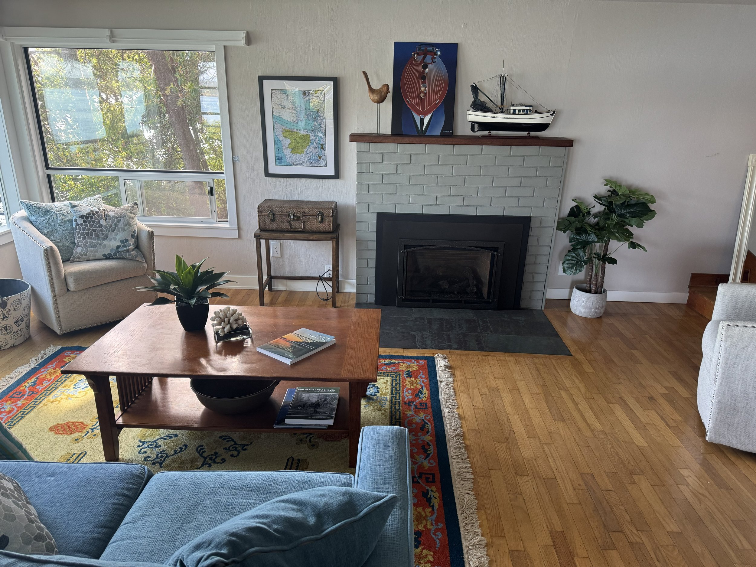 The living room is the perfect spot to look west through the trees to view Ben Ure Island and Strawberry Island.  The channel between the islands is the pathway the Orca whales take from outside of Deception Pass into the waterways around Whidbey Isl
