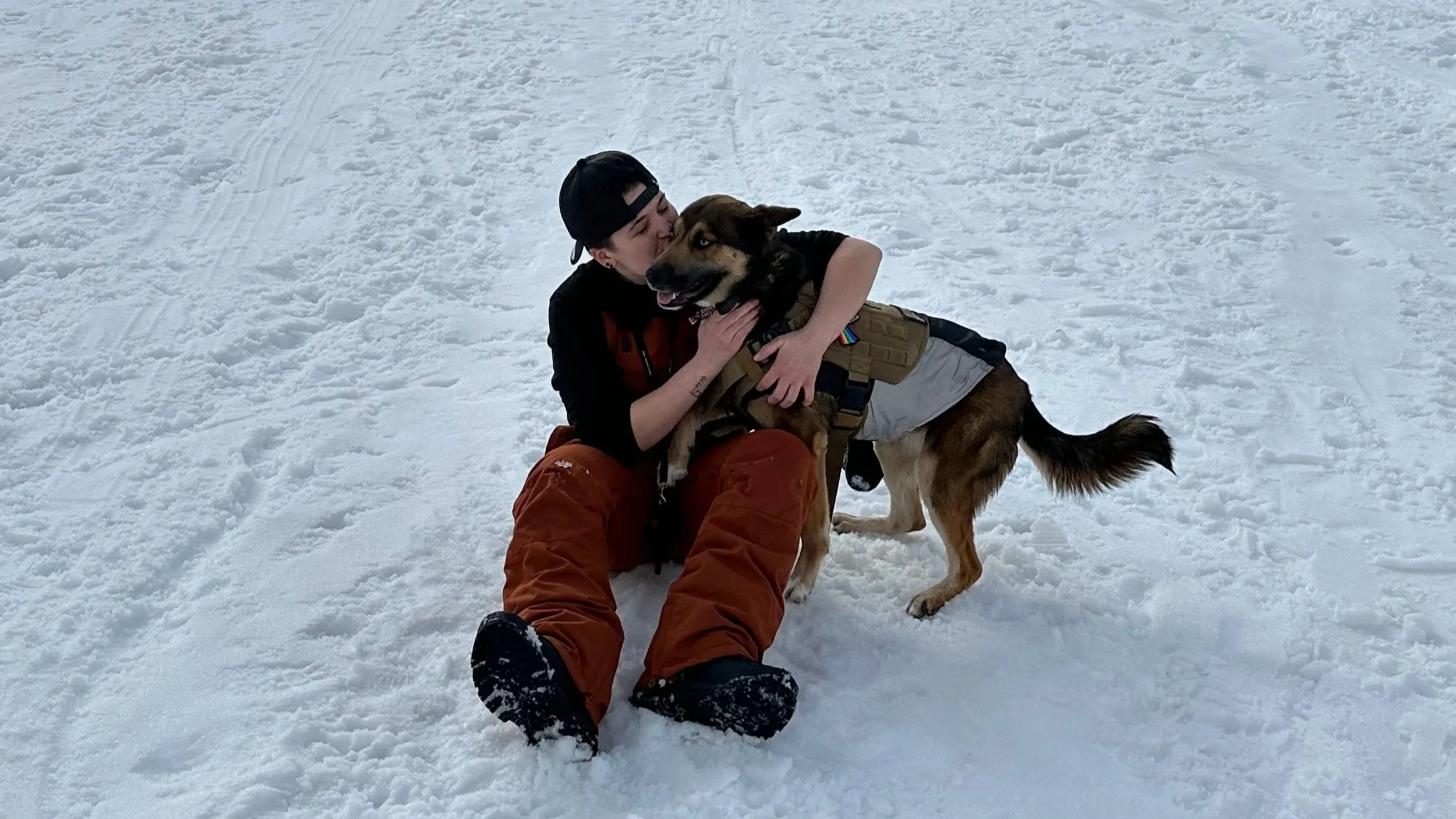 Kashie's Korner owner with Kashie during a snowy outdoor adventure.