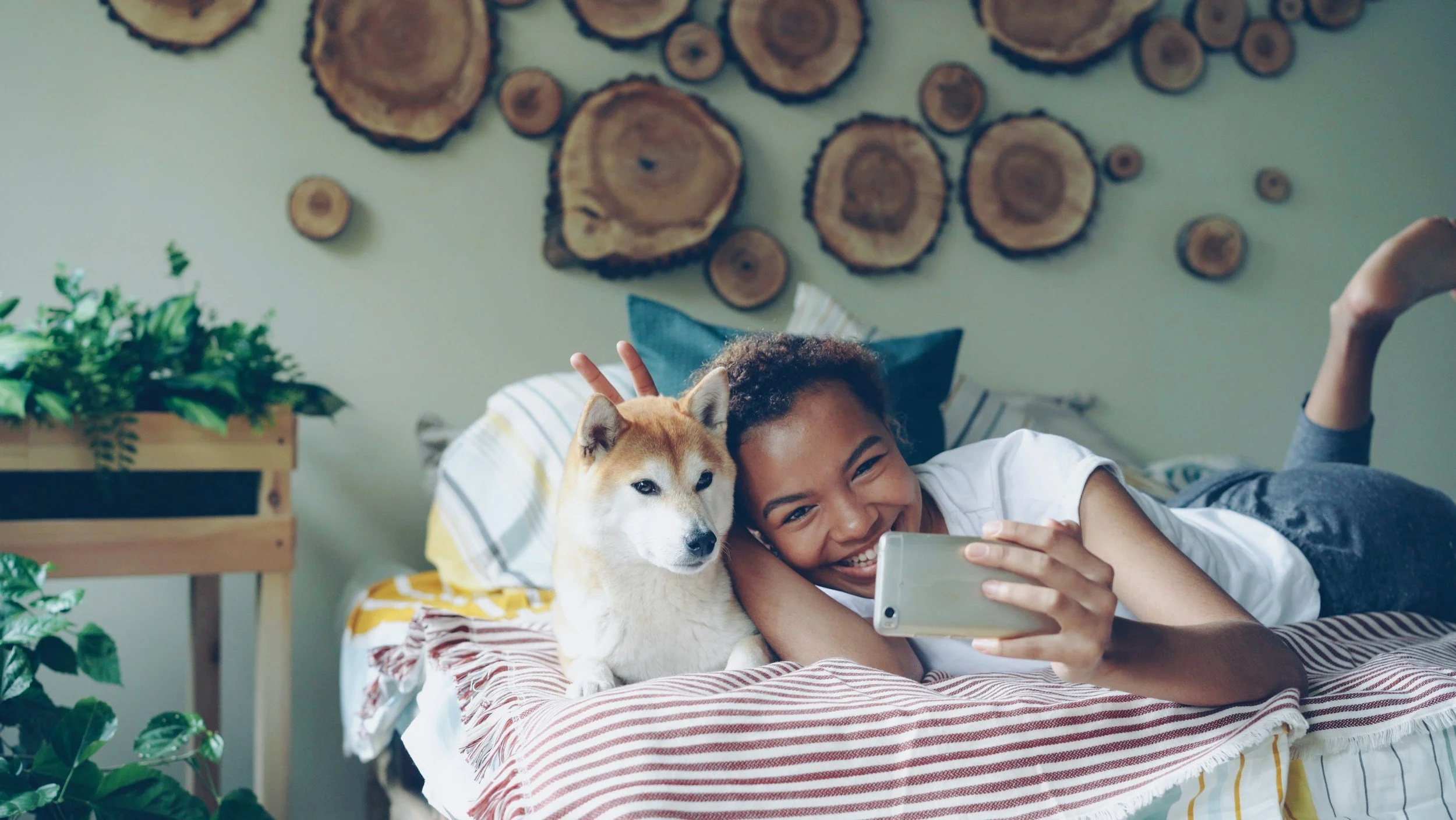 Pet care provider taking a selfie with a dog during an in-home visit.
