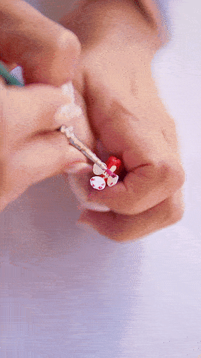 A person receiving a vaccination shot in their arm with a small teddy bear sticker nearby.