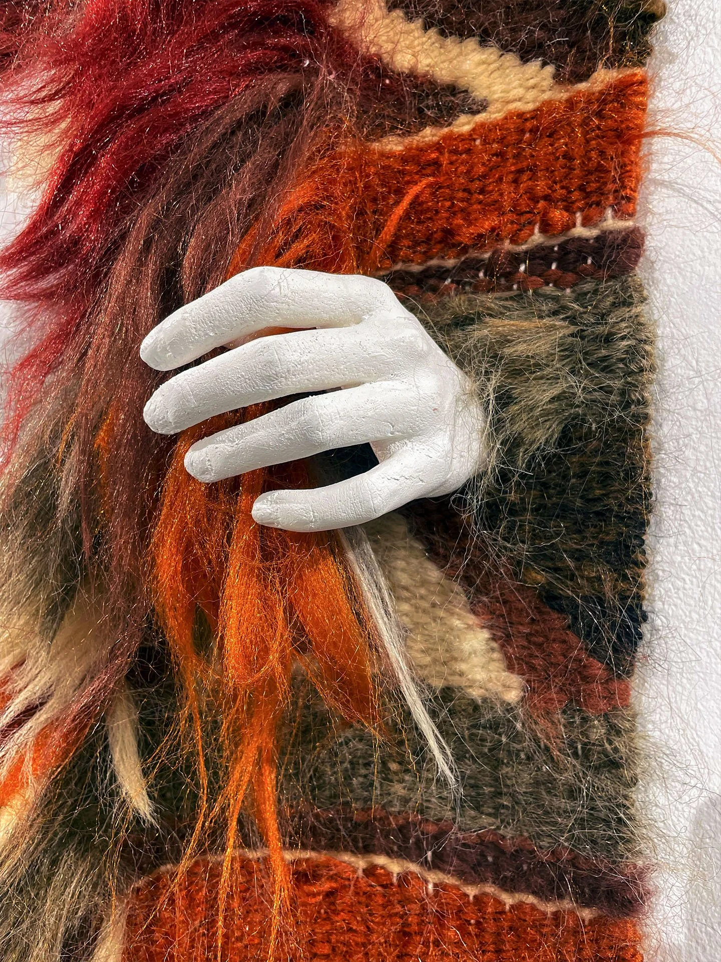 "In the Weave", 2025. Woven hair, resin, plaster, wood