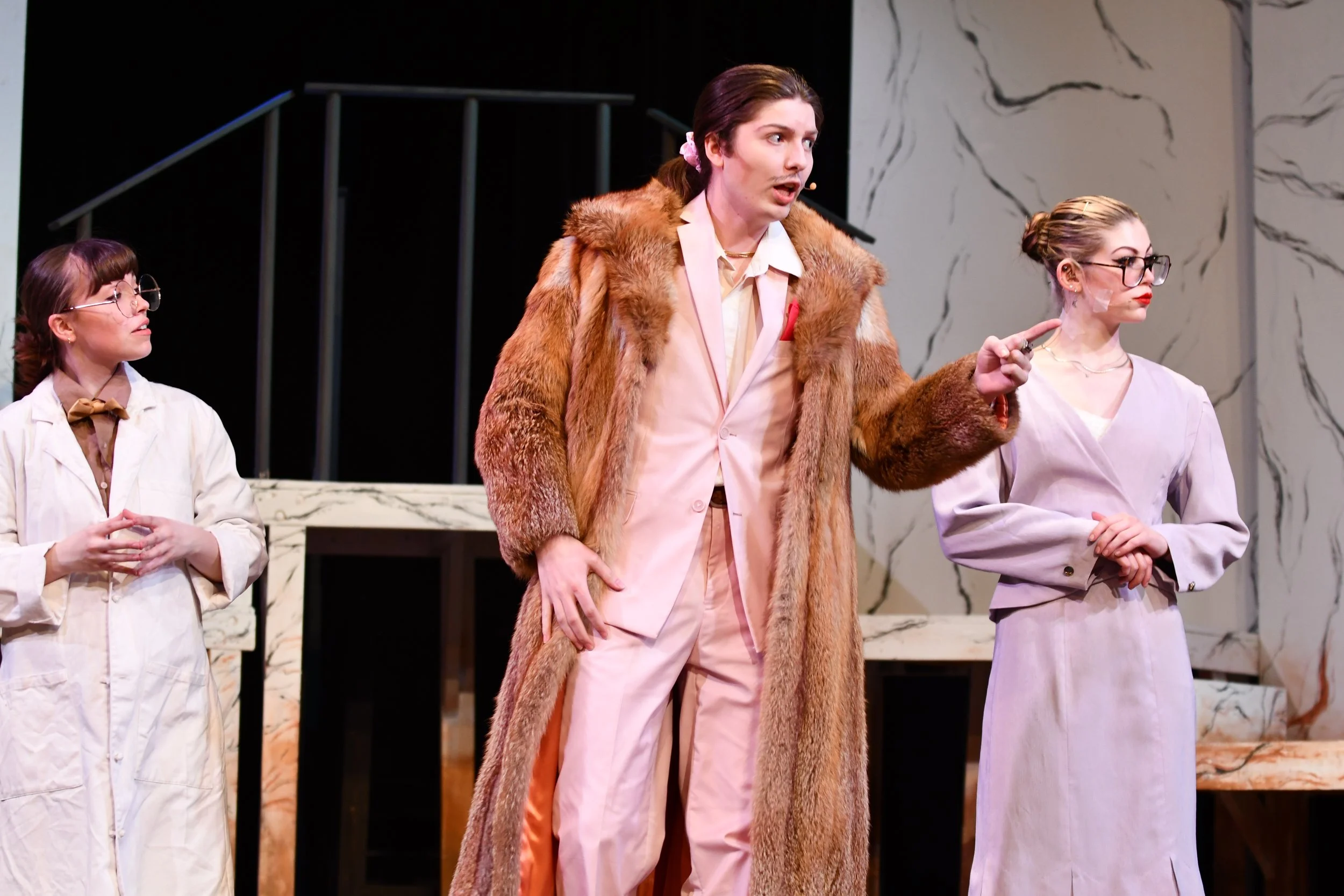 "Urinetown", Spring 2026. Directed by Claire D. Kolheim. Written by Greg Kotis. Photo: (left to right) Nat Gunter, Emma Wyckoff, Kara Lynn Noggle.