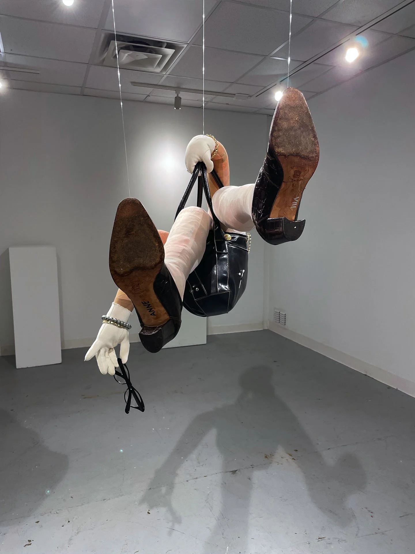 "The Little Old Lady Who Lived In Her Purse", 2025. Various fabrics, stockings, women’s leather heels, purse, glasses, gloves, jewelry, pins.
Winner of the 2025 Rhodes College Juried Art Show