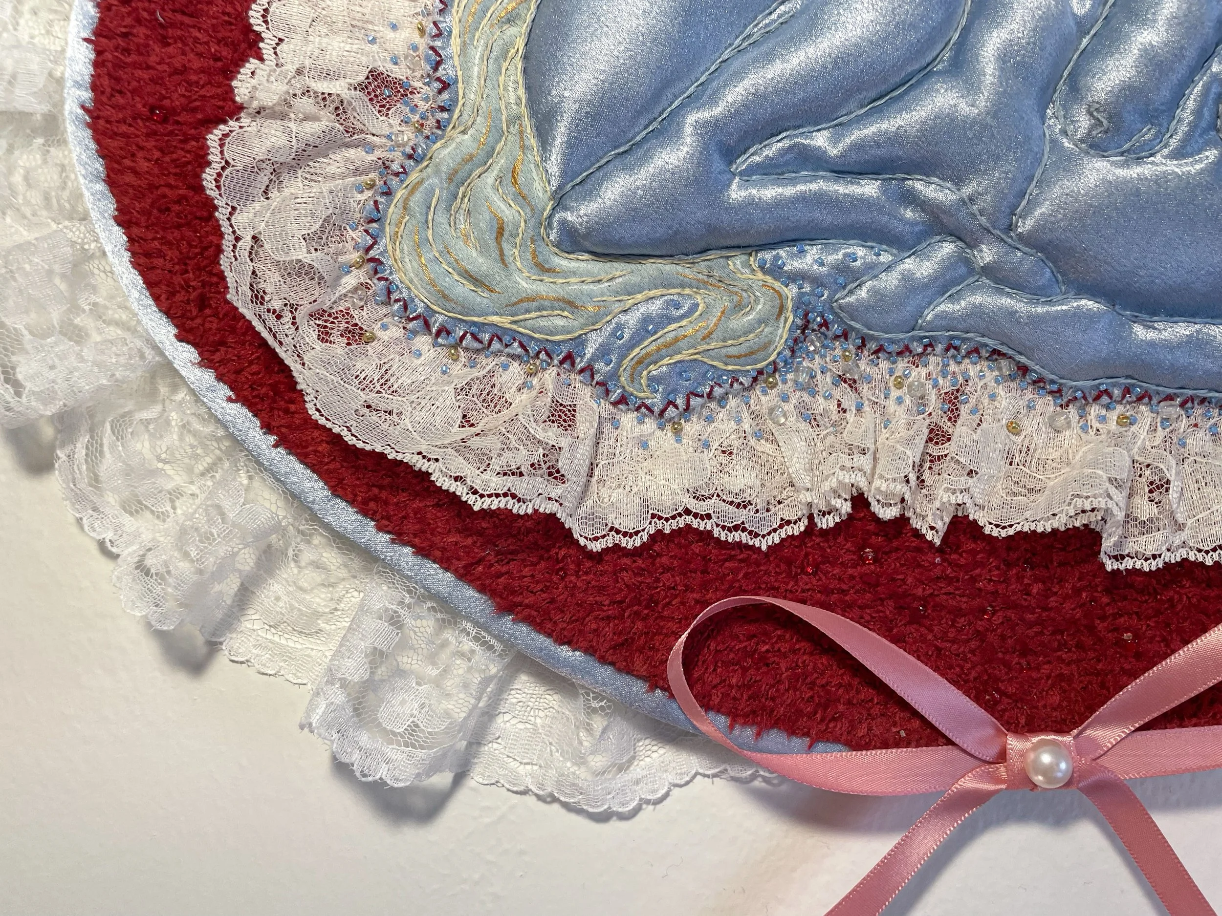 "Blue Unicorn," (2026). Satin, lace, canvas, plush fabric, embroidery floss, metallic thread, beads, Polyfil. 