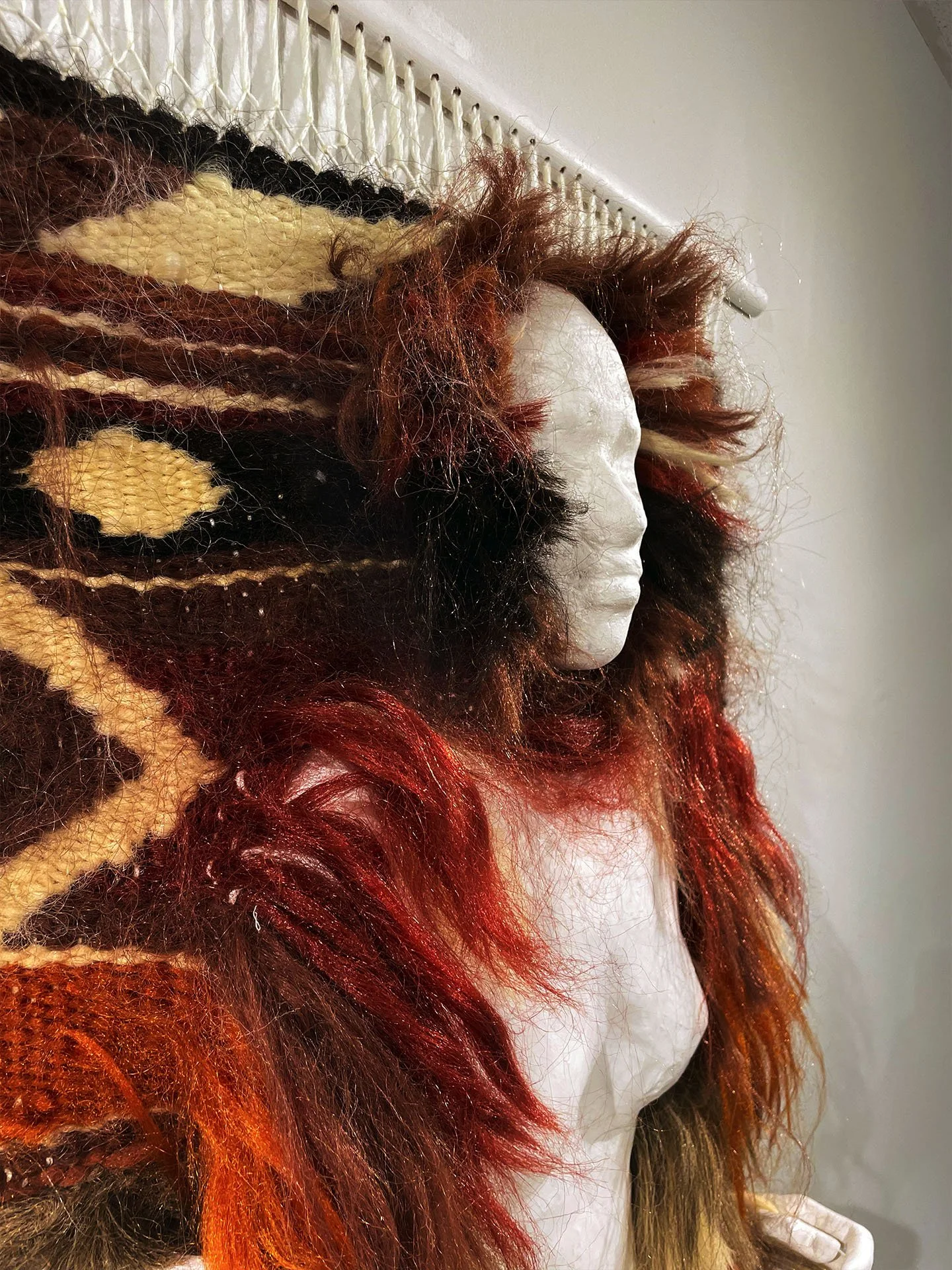 "In the Weave", 2025. Woven hair, resin, plaster, wood