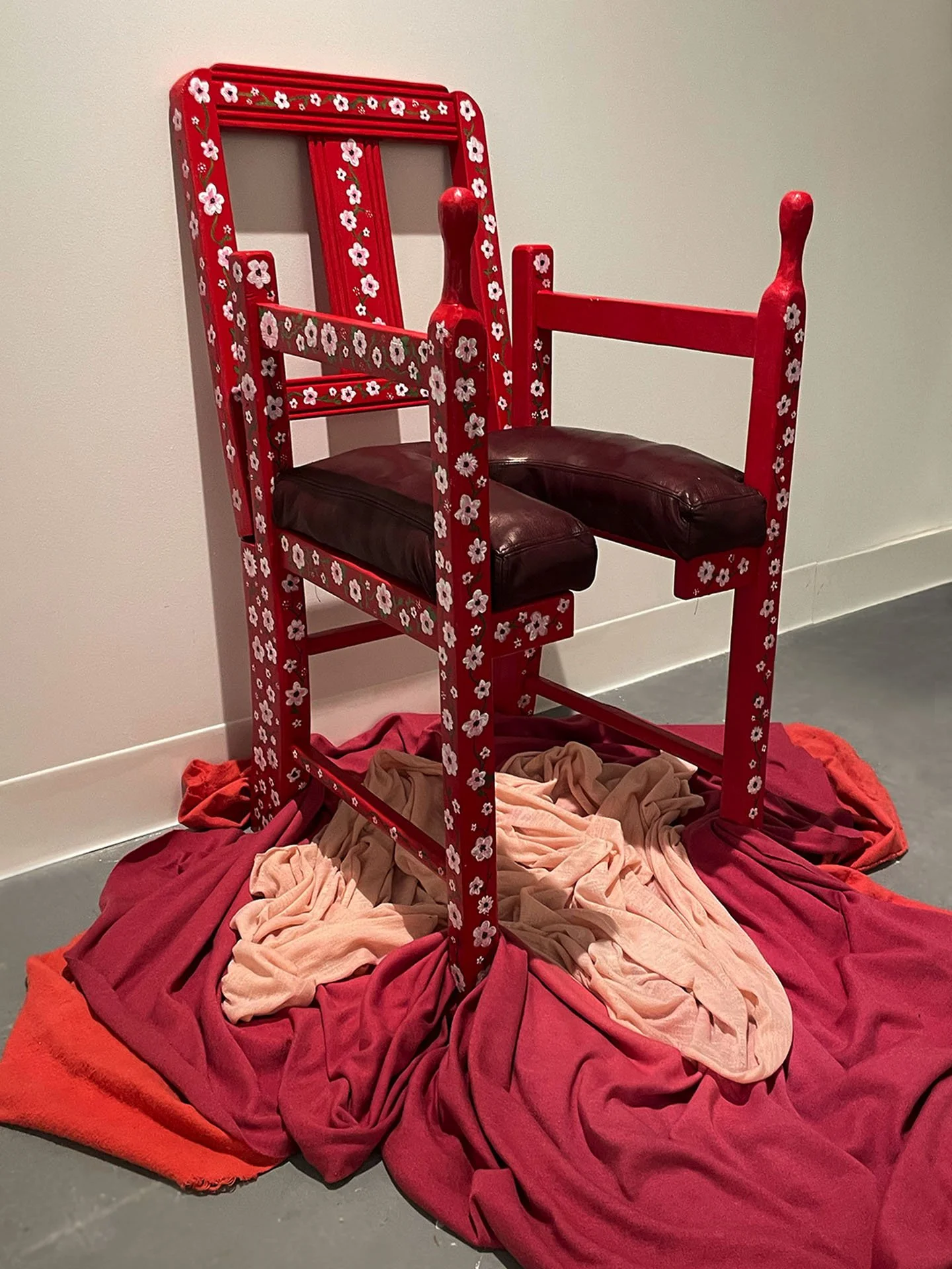 "Mama's Chair (Birthing Chair)", 2023. Discarded children’s chair, wood, leather, paint, hand-dyed fabric