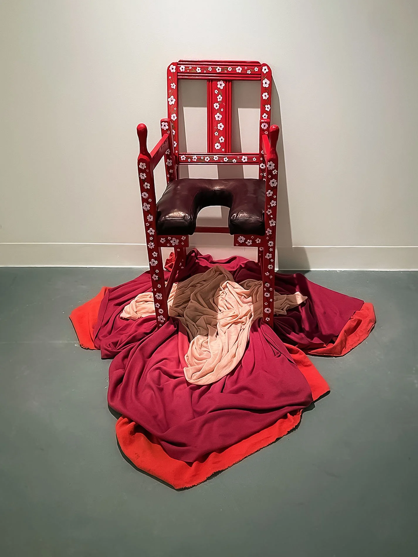 "Mama's Chair (Birthing Chair)", 2023. Discarded children’s chair, wood, leather, paint, hand-dyed fabric