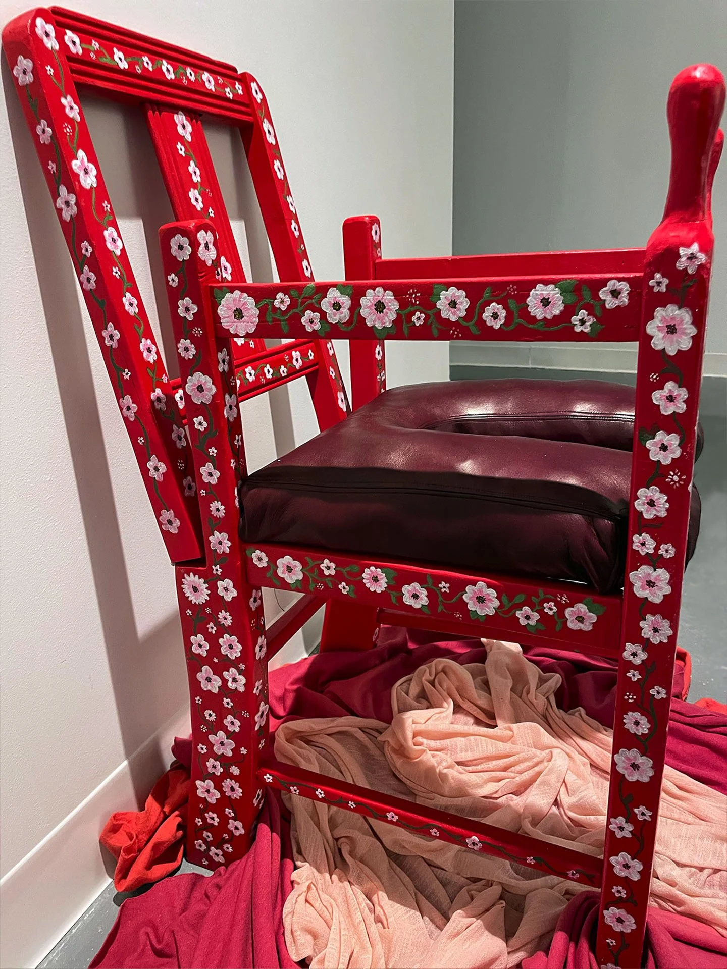 "Mama's Chair (Birthing Chair)", 2023. Discarded children’s chair, wood, leather, paint, hand-dyed fabric