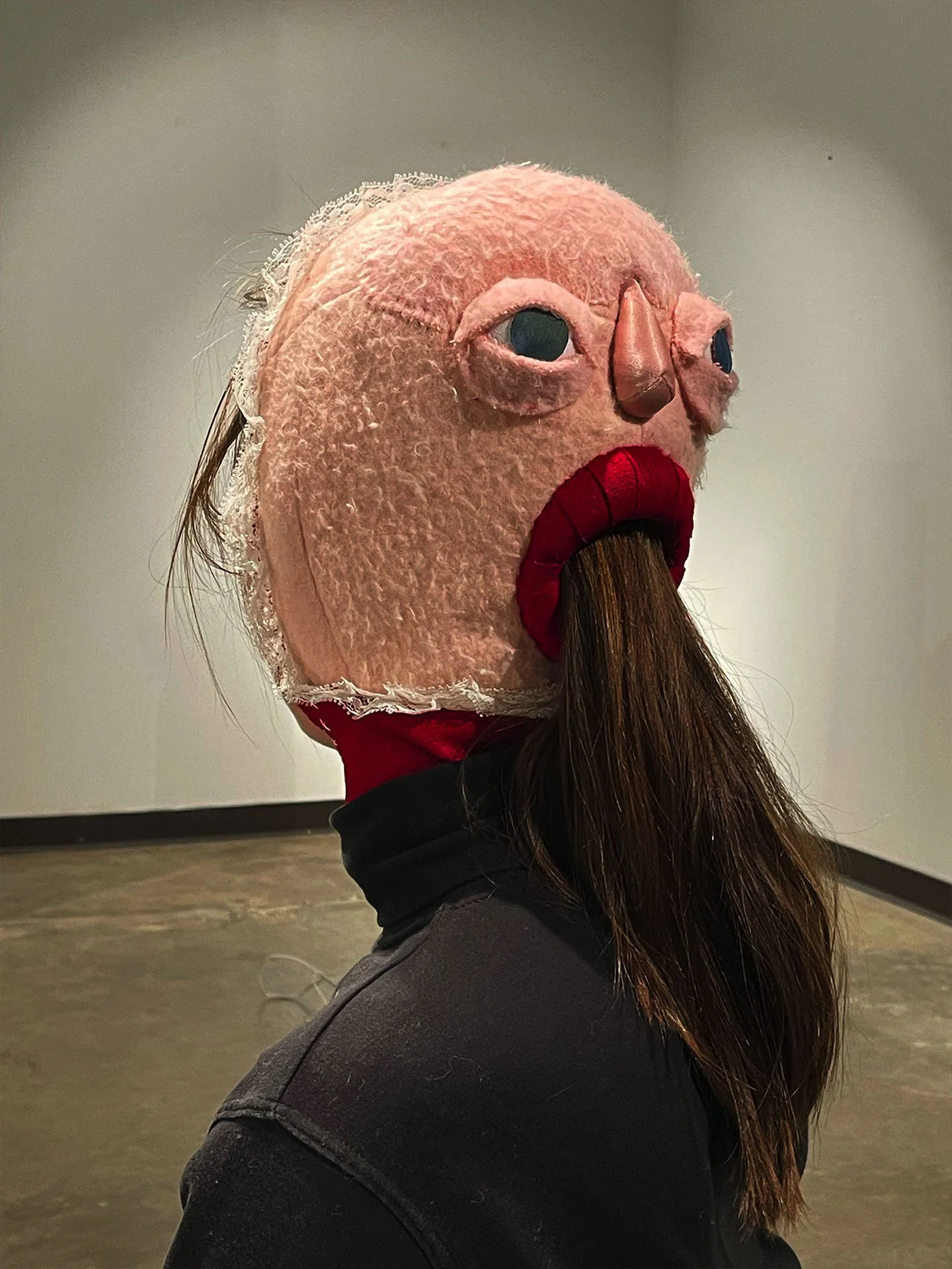 "Eyes In the Back of Her Head", 2026. Installation & Wearable Art. Fleece & various fabrics, lace, embroidery floss, foam clay, Polyfill. Photographed by Alana Reese-Walker.