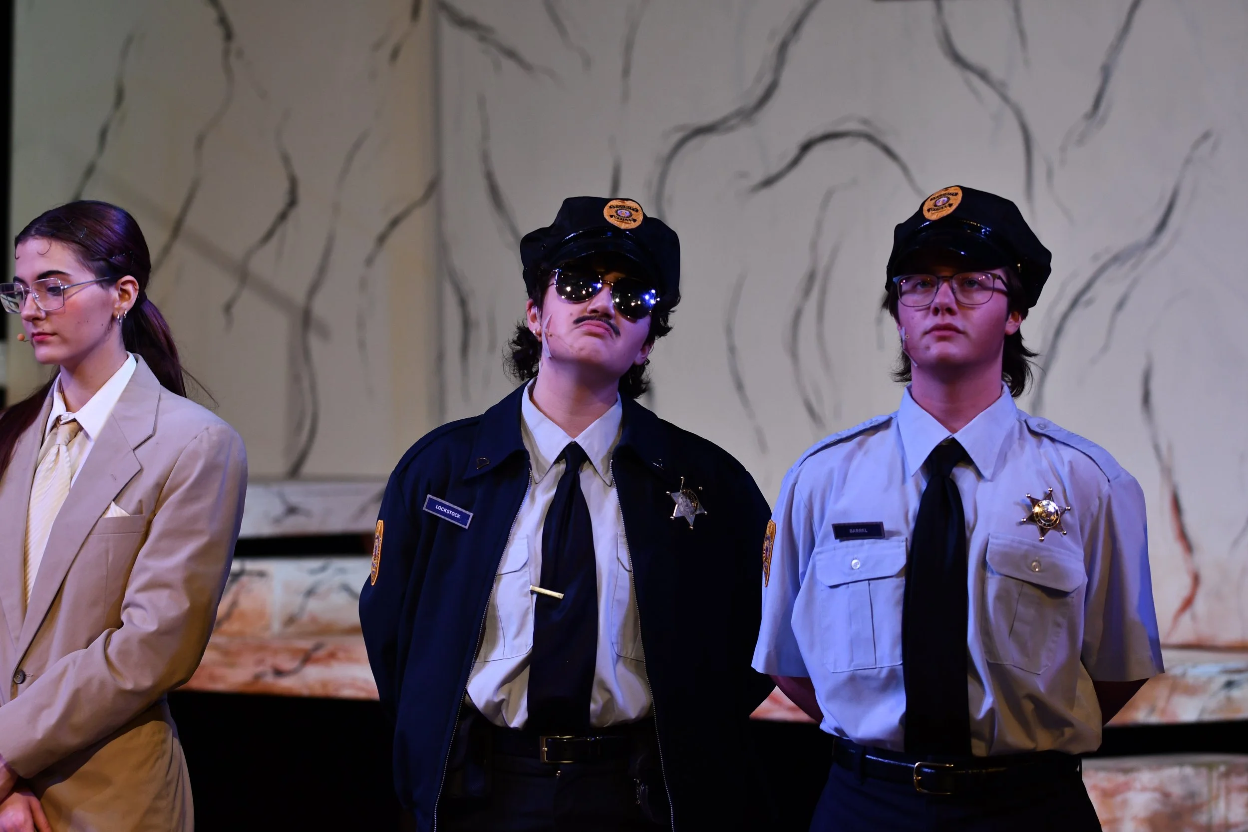 "Urinetown", Spring 2026. Directed by Claire D. Kolheim. Written by Greg Kotis. Photo: (left to right) Cordelia O'Bradovich, Wae Methvin, Jamie Gau.