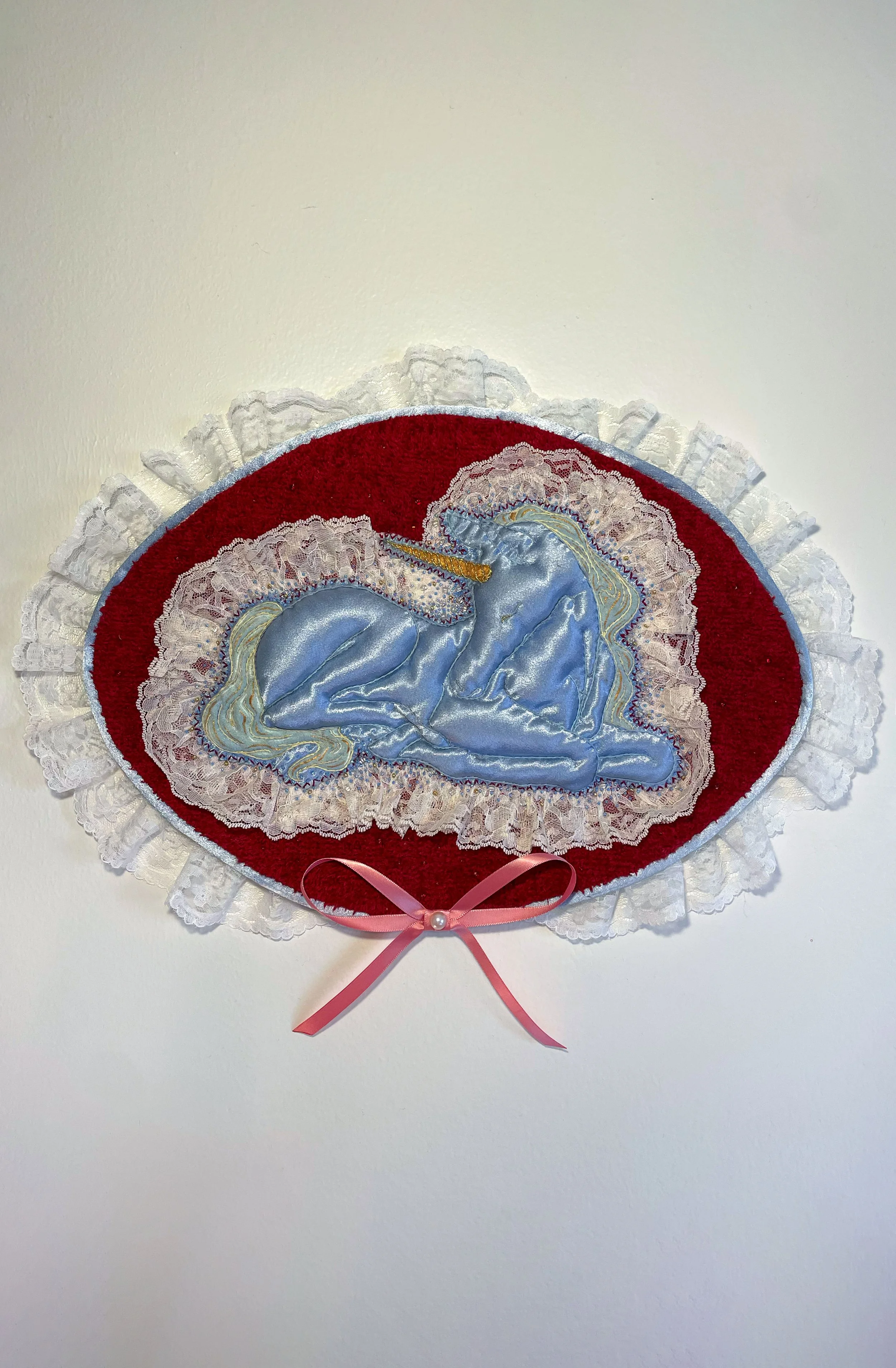 "Blue Unicorn," (2026). Satin, lace, canvas, plush fabric, embroidery floss, metallic thread, beads, Polyfil. 