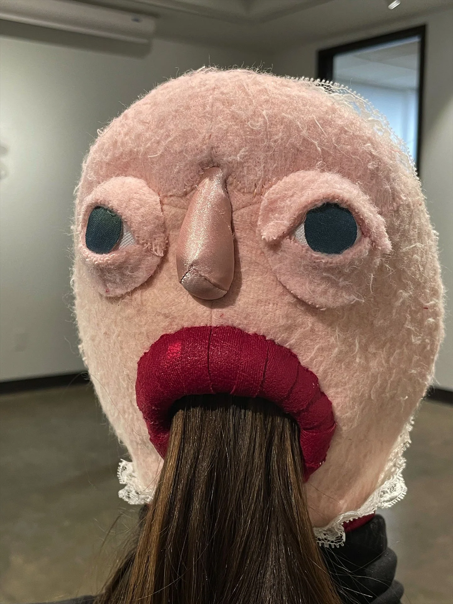 "Eyes In the Back of Her Head", 2026. Installation & Wearable Art. Fleece & various fabrics, lace, embroidery floss, foam clay, Polyfill. Photographed by Alana Reese-Walker.