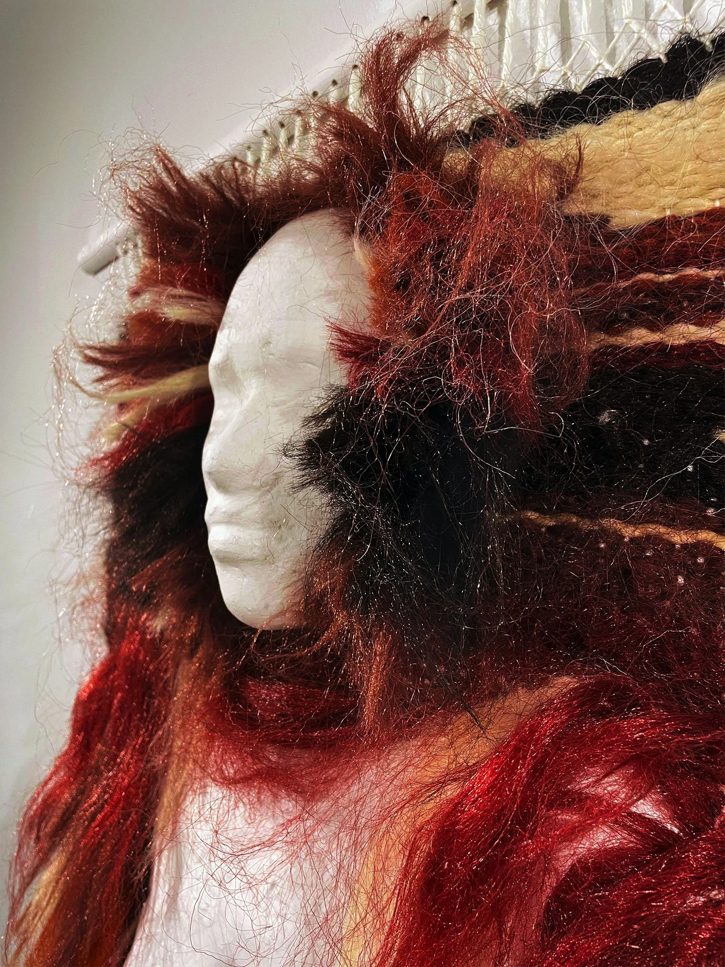 "In the Weave", 2025. Woven hair, resin, plaster, wood