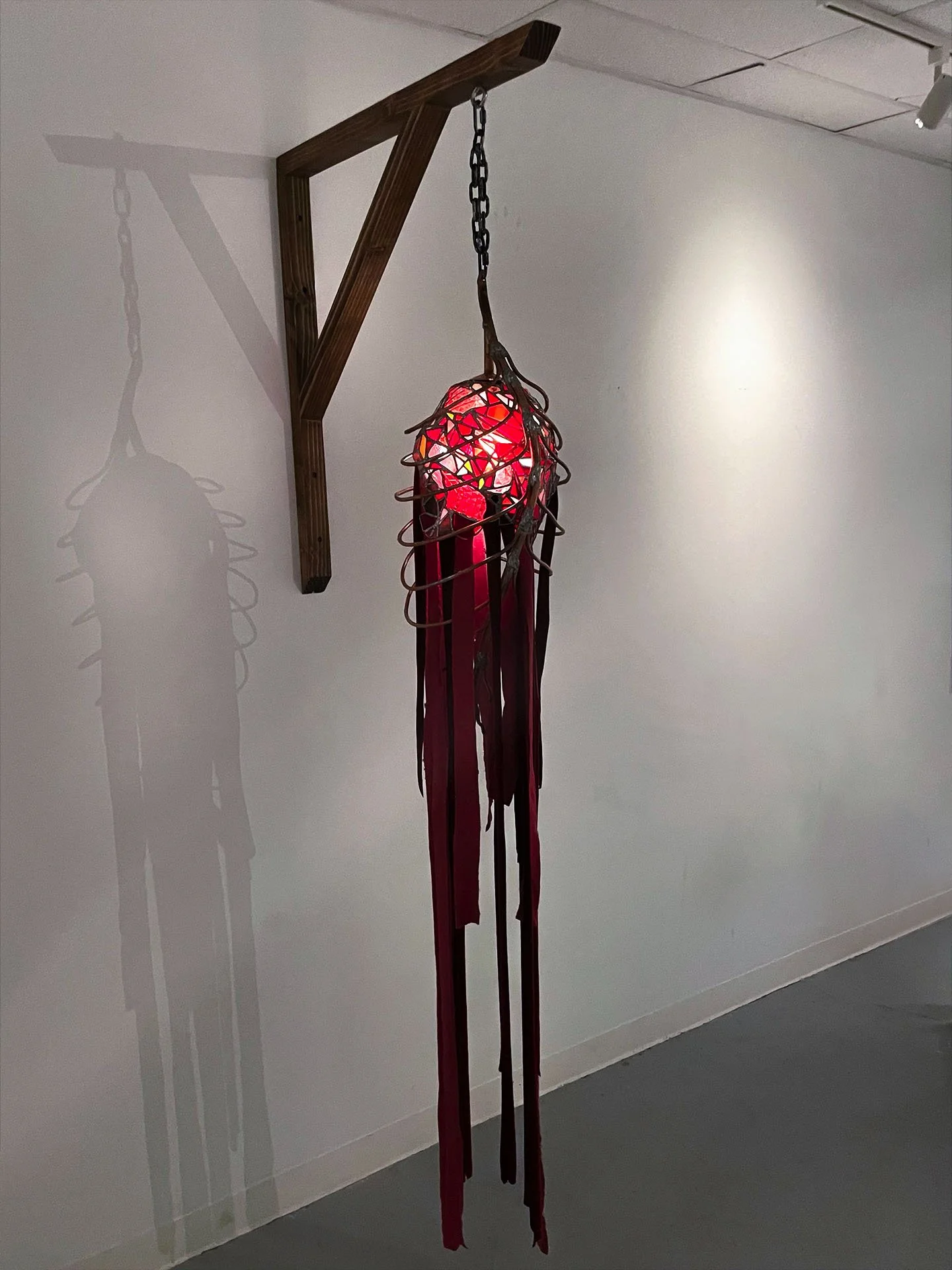 "Cadavera Vero Innumera", 2025. Stained glass, copper, solder, velvet, pine wood, chain, LED lights.