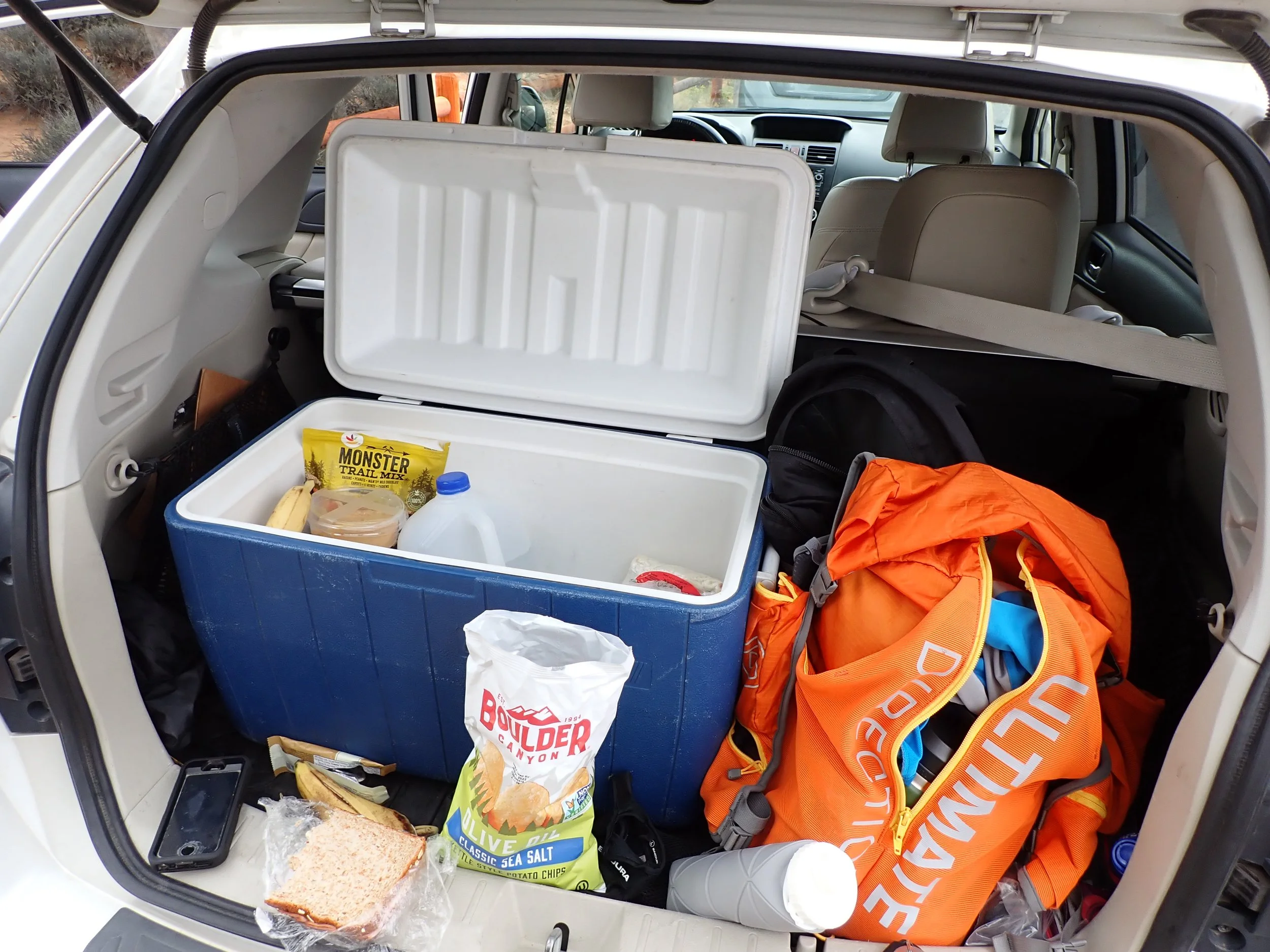 Cooler, backpack, and hiking gear packed for a day of exploring Moab