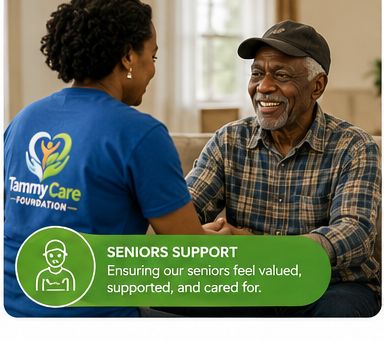 A young woman in a blue Tammy Care Foundation T-shirt talking to an elderly man with a smile in a bright room.