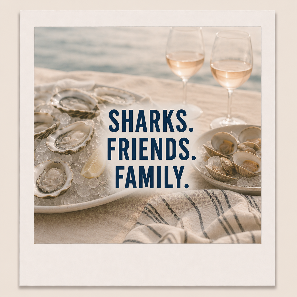 Coastal oyster and rosé flat lay featuring the Raised by Reality phrase “Sharks. Friends. Family.”