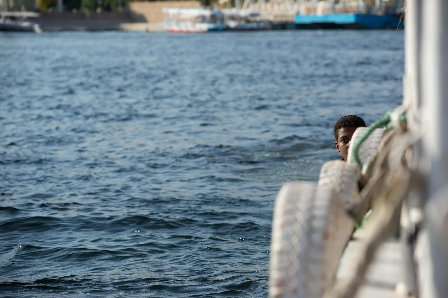 It&rsquo;s like hopping trains, the kids would grab onto boats on old paddle boards traverse the Nile with ease. #peekaboo 
.
.
.
.
.
.
.
.
.
.
.
#hitchhiking #hitched #paddleboards #travelphotography #travel #traveling #fff #photographer #photograph