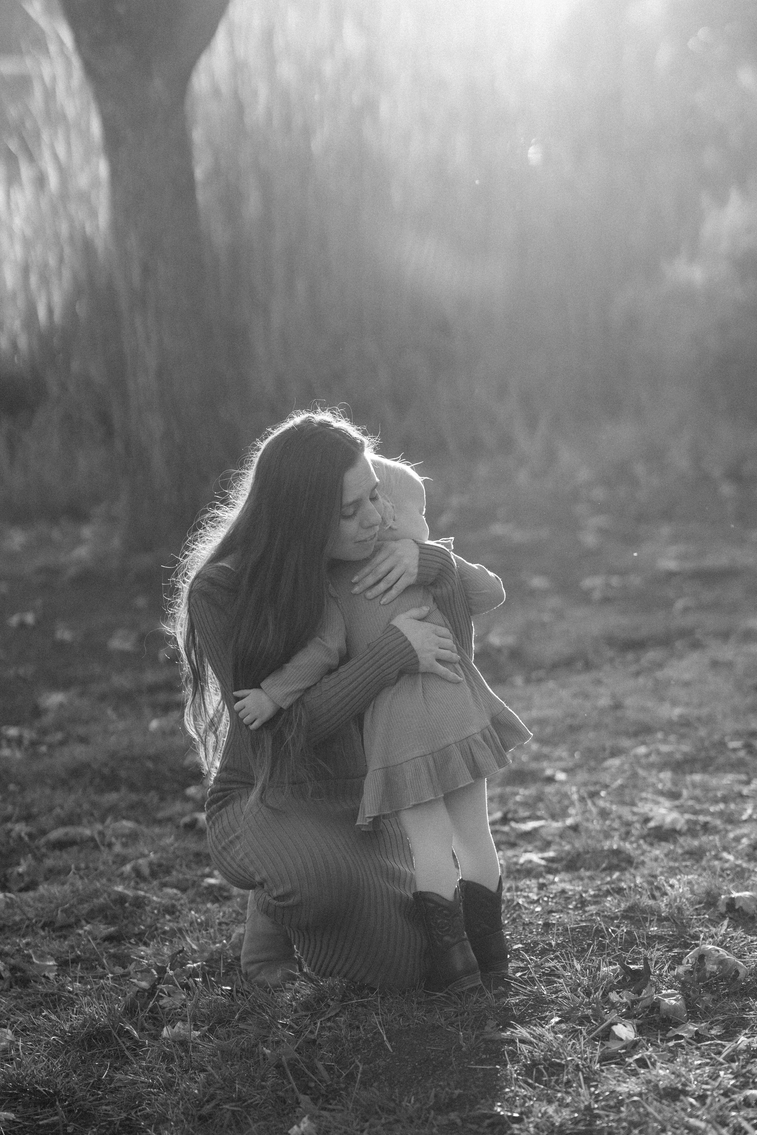 Mother embracing her young daughter during an intimate outdoor family photography session in Sonoma County, California.