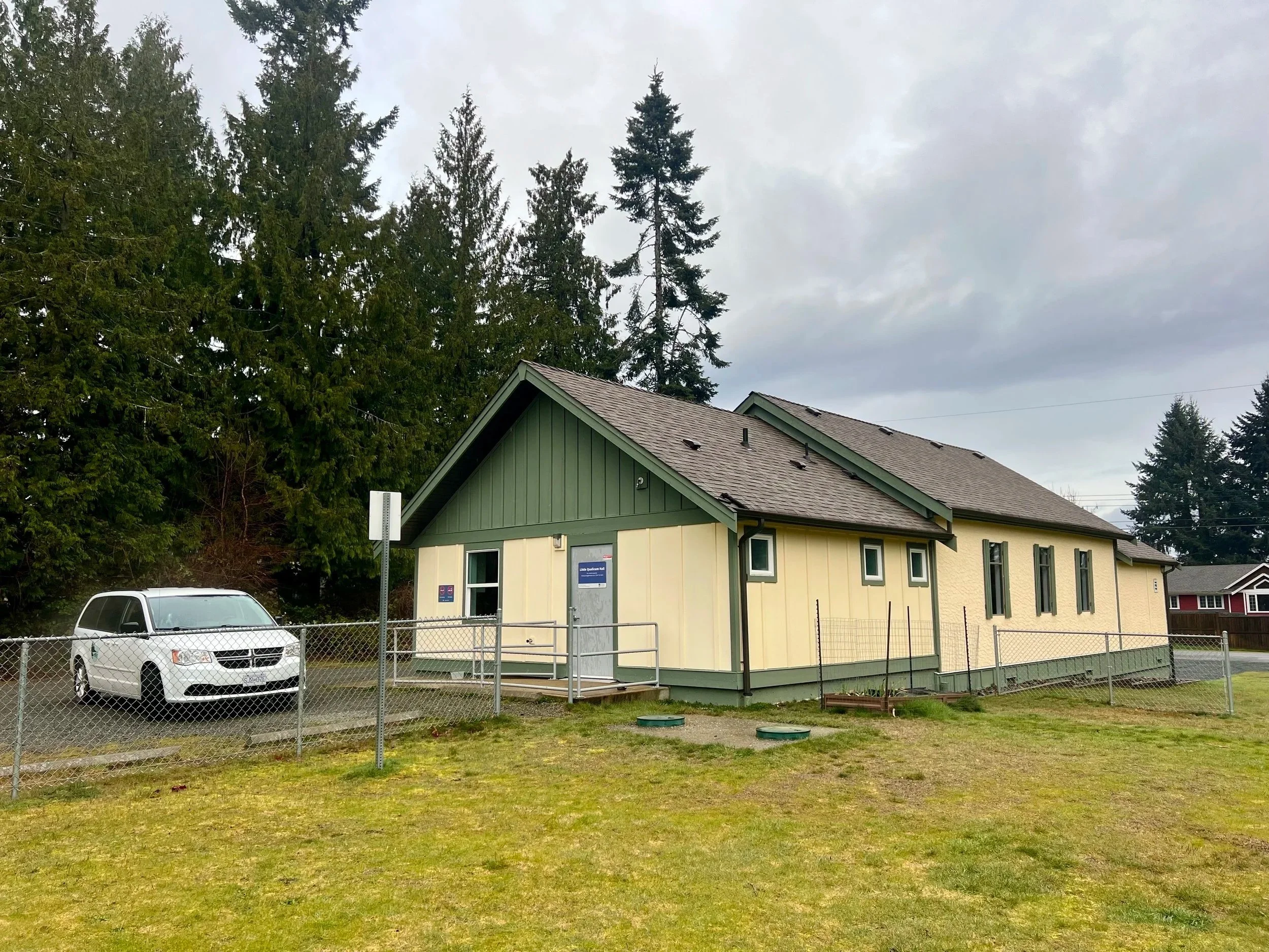 green building with white car outside