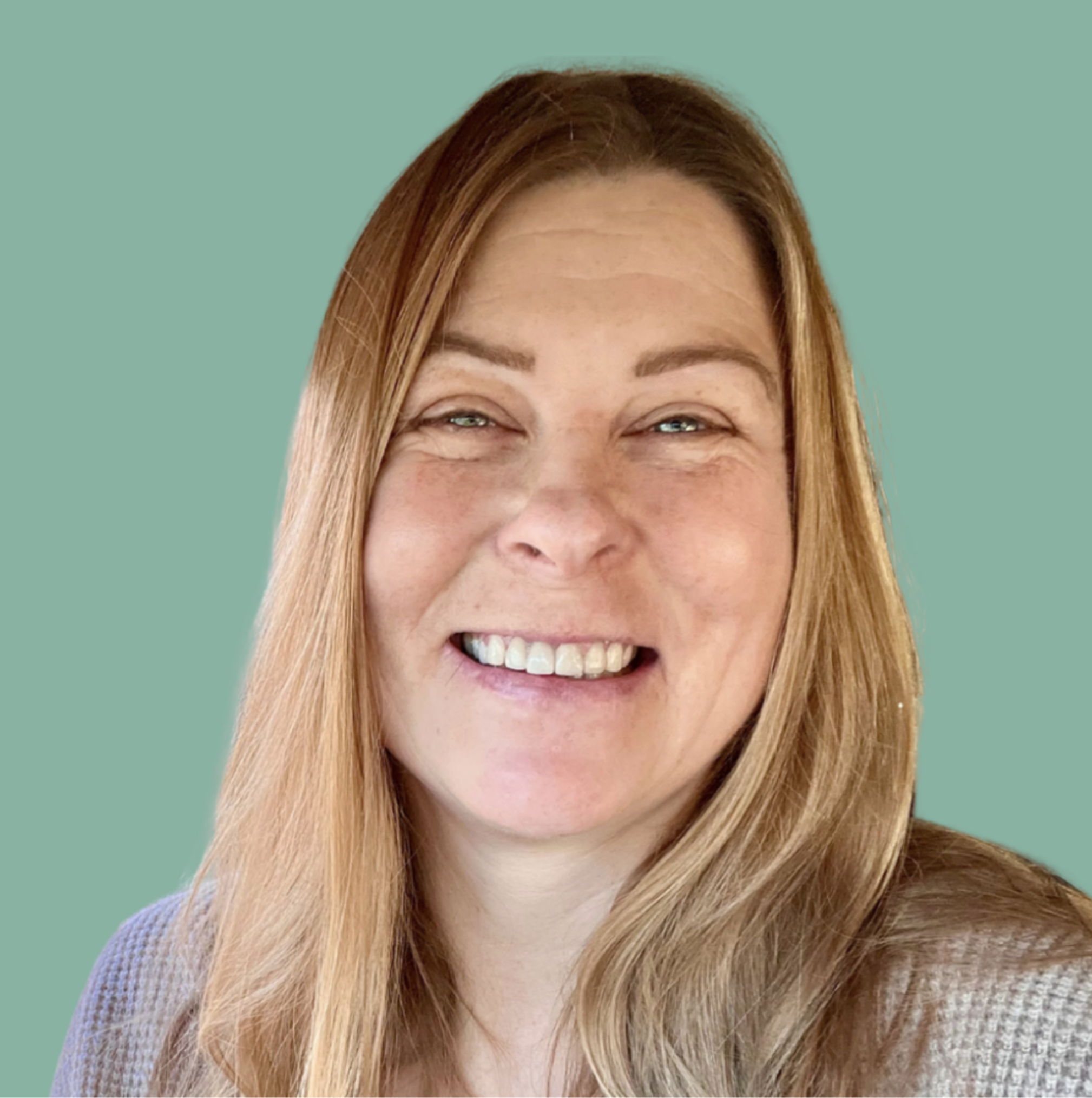 Close-up of a smiling woman with blonde hair against a teal background.
