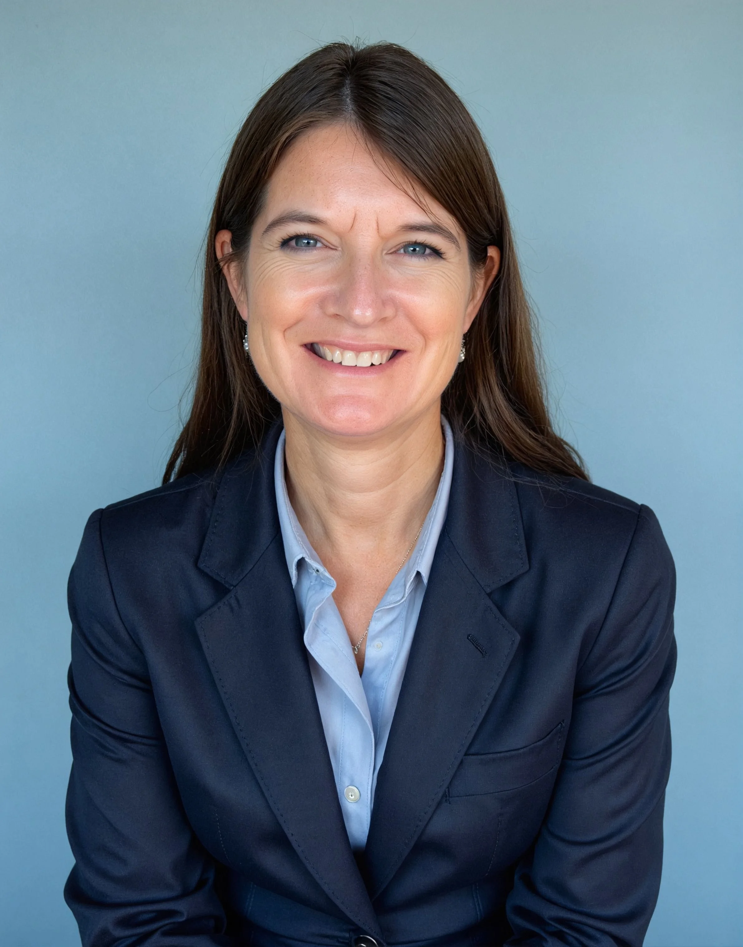 Picture of Adene Karhan, brown hair blue eyes wearing a blue blazer