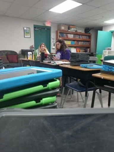 Mr. Barbero and Ms. Smith working into the late hours with other team members to get iPads ready for students.