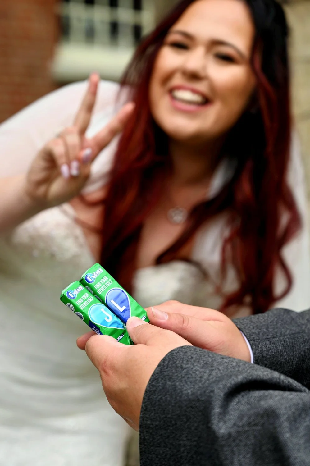 Personalised wedding detail shot — couple's initials on Extra chewing gum packaging captured with creative bokeh — detail wedding photography by Tasha Boorman, Nottinghamshire wedding photographer