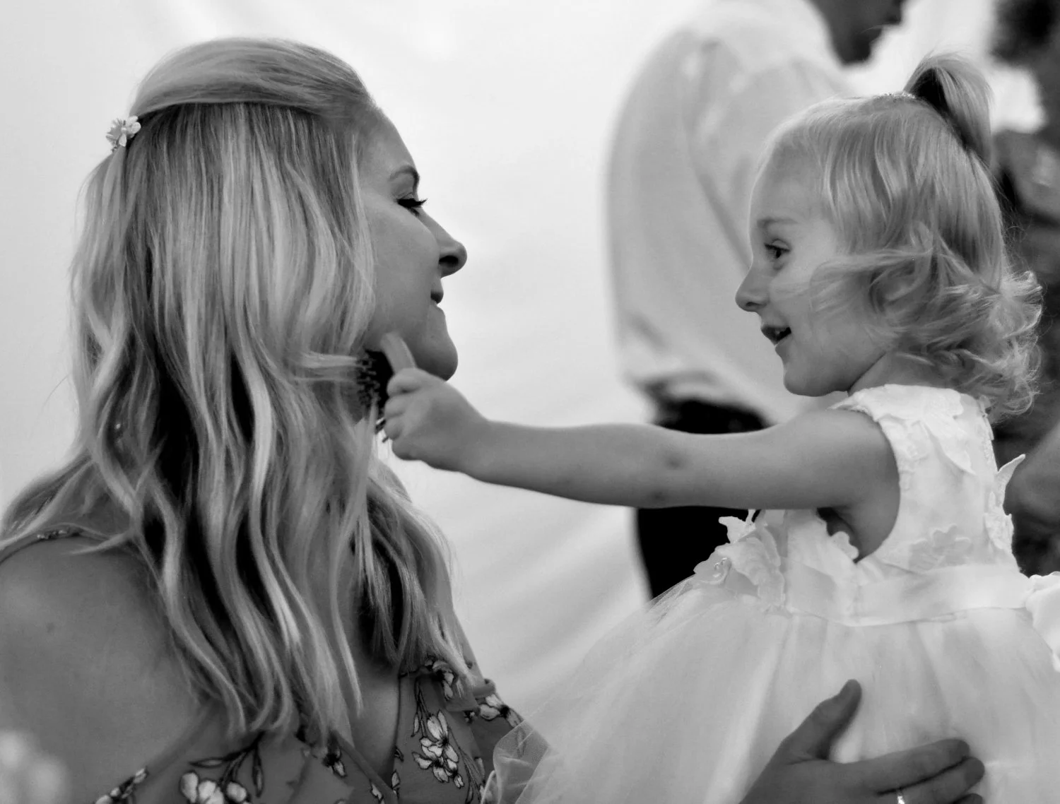 Candid moment between mother and flower girl at a Nottinghamshire wedding — natural documentary wedding photography by Tasha Boorman