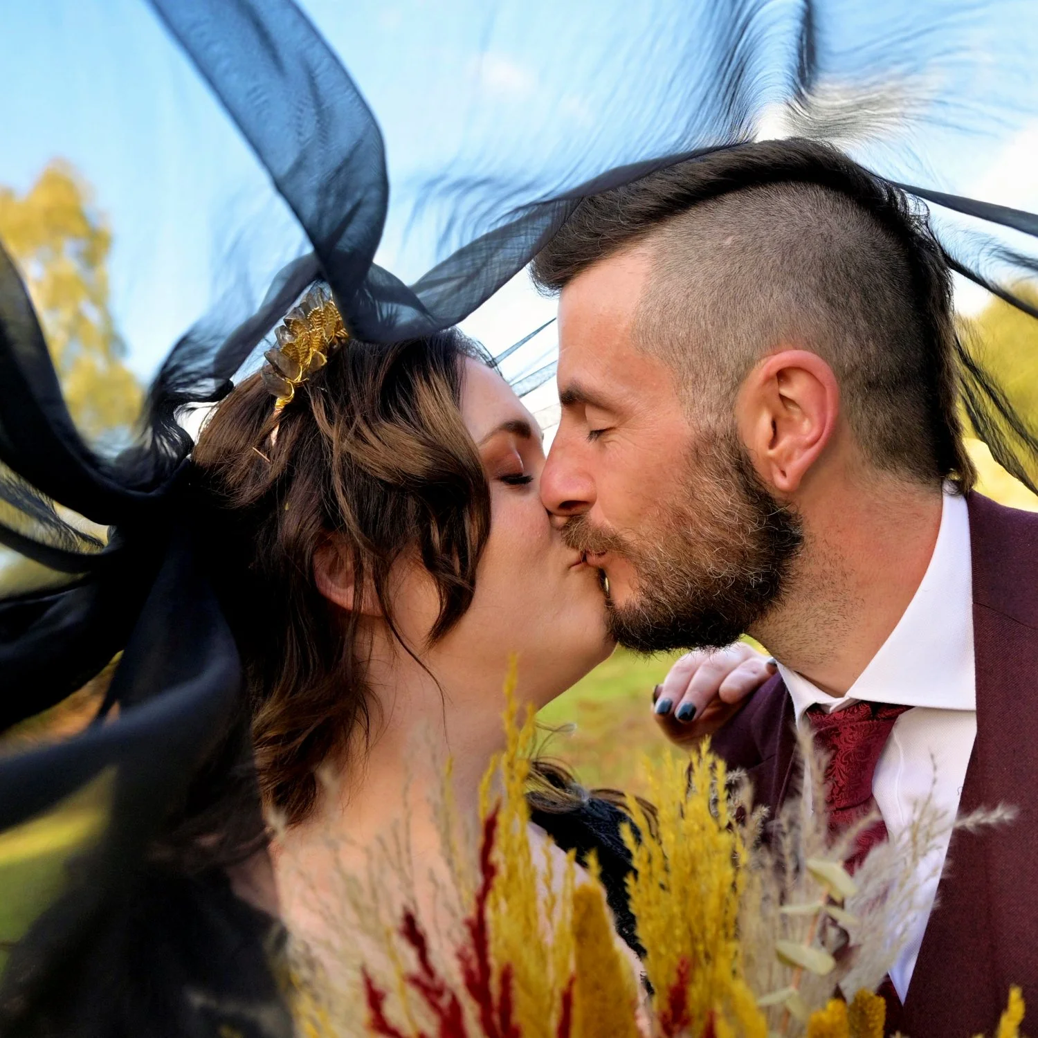 Alternative gothic couple kissing wrapped in a dramatic black veil with dried pampas bouquet — creative alternative wedding photography by Tasha Boorman, Nottinghamshire wedding photographer