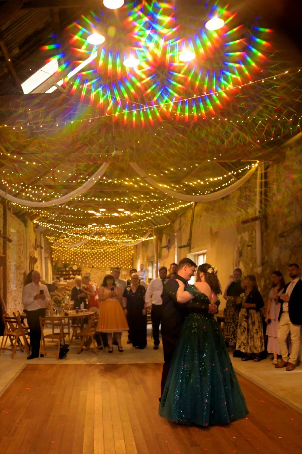 Couple's first dance captured with a creative starburst filter in a stunning fairy light barn wedding venue — creative wedding photography by Tasha Boorman, Nottinghamshire wedding photographer