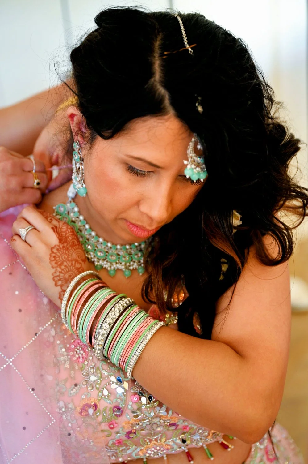 Bride getting ready in her beautiful sari with traditional bangles, henna and jewellery during an Asian wedding — detail wedding photography by Tasha Boorman, Nottinghamshire multicultural wedding photographer