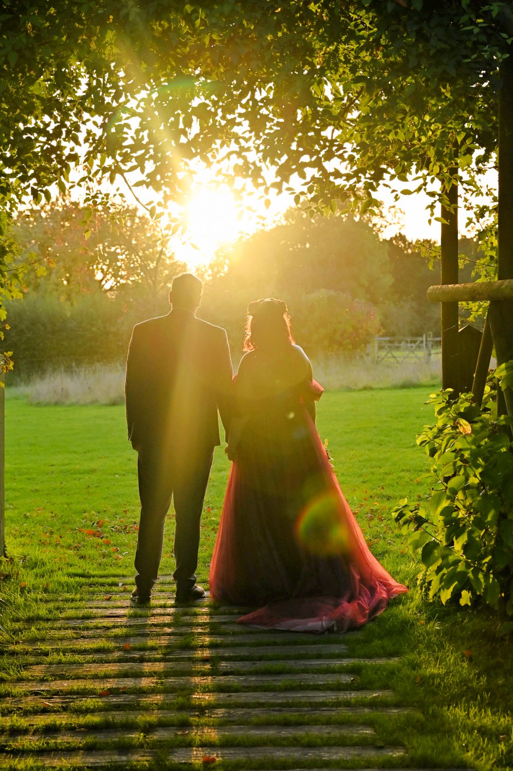 wedding photos of bride and groom sharing a moment at sunset capturing a beautiful sunburst