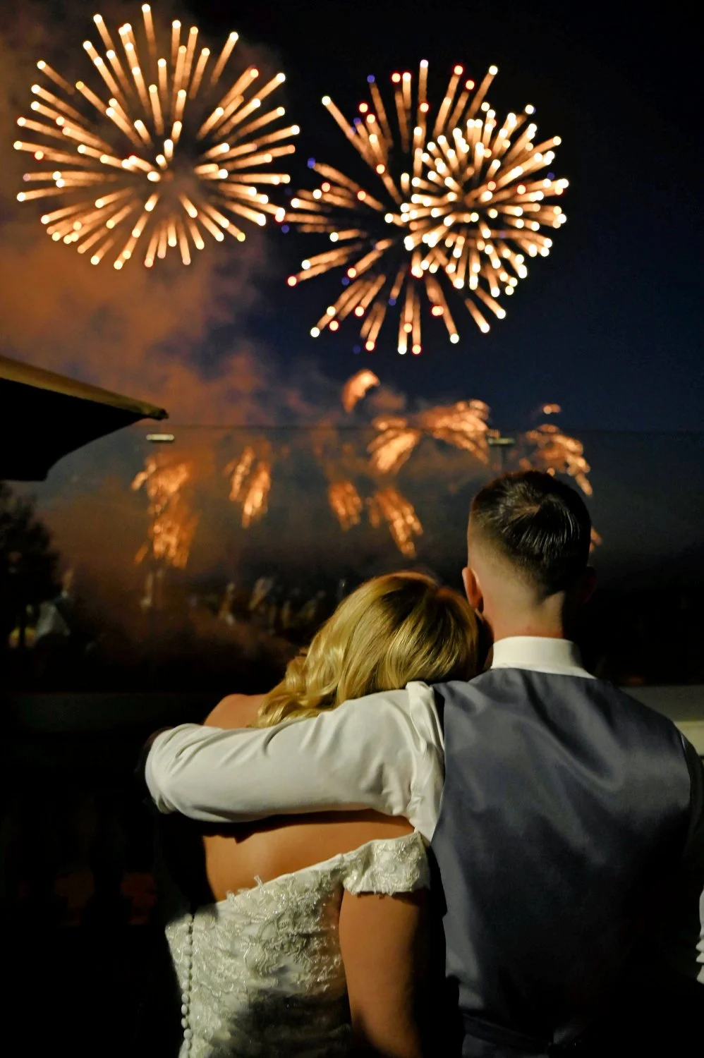 Bride and groom watching fireworks together at the end of their wedding evening. creative night wedding photography by Tasha Boorman, Nottinghamshire wedding photographer