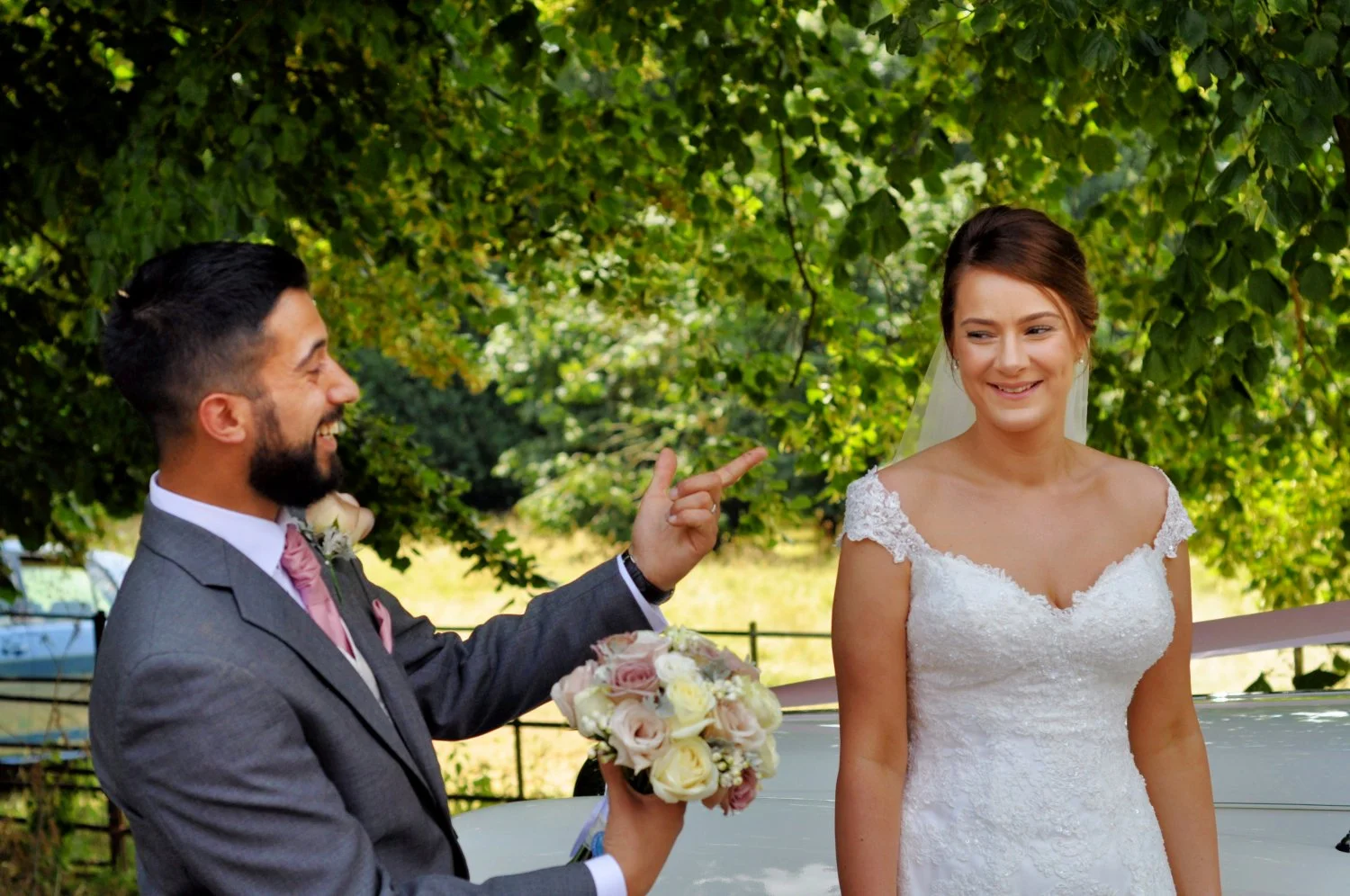Groom proudly showing off his beautiful bride in a candid playful moment — natural documentary wedding photography by Tasha Boorman, Nottinghamshire wedding photographer