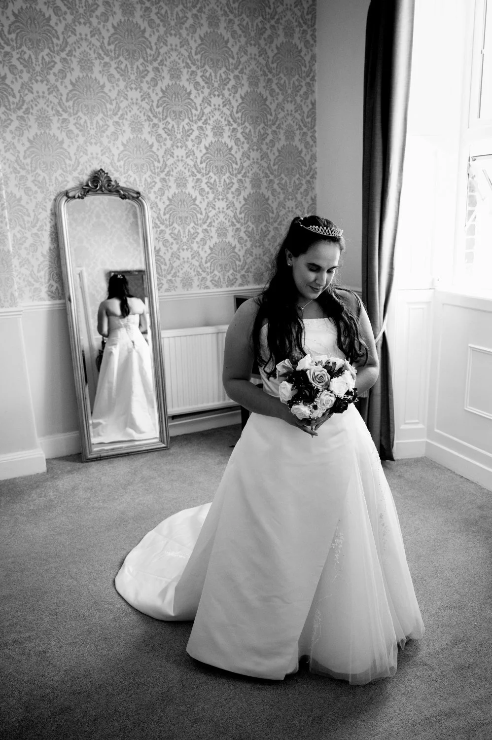 Bride in her wedding dress with tiara reflected in a vintage gold mirror during getting ready — bridal portrait by Tasha Boorman, Nottinghamshire wedding photographer