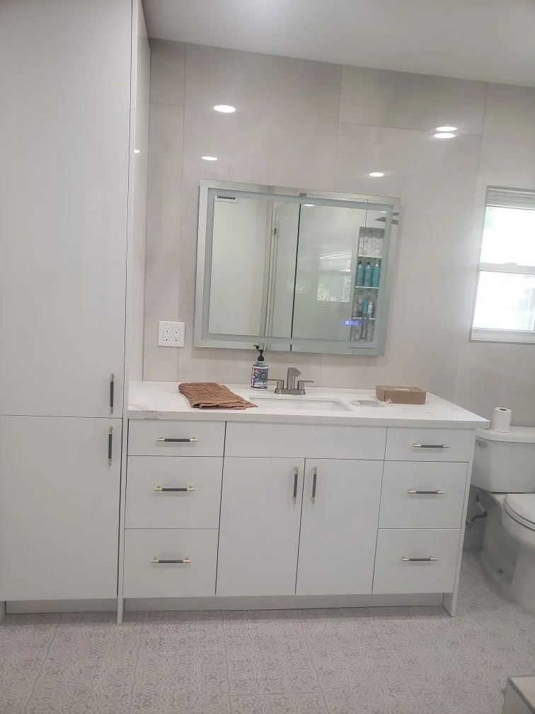 #J     A modern bathroom with new white cabinets