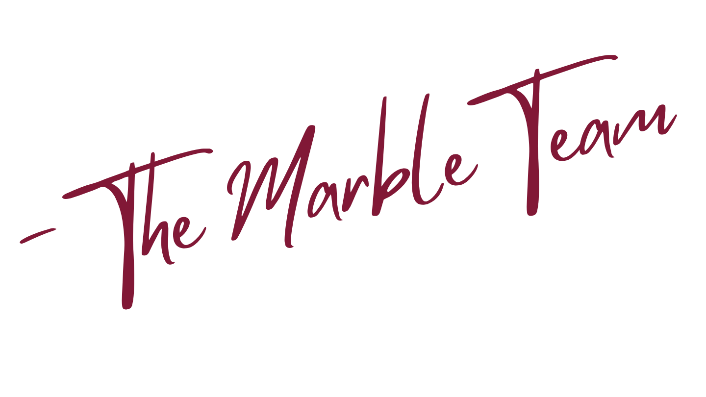 Stylized text reading "The Marble Team" in purple cursive font on a transparent background.