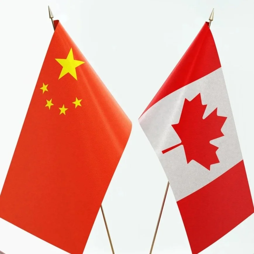 Chinese and Canadian flags crossed against a white background.