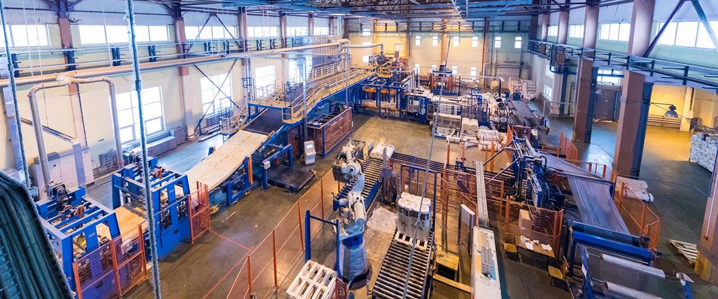 An industrial manufacturing facility with automated machinery and robotic arms.