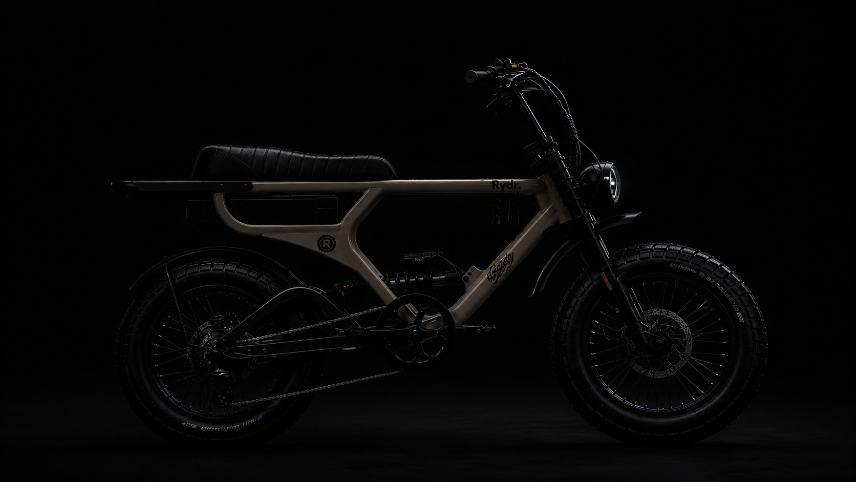 Electric motorcycle with a beige frame, black wheels with knobby tires, black seat, and black handlebars against a dark background.