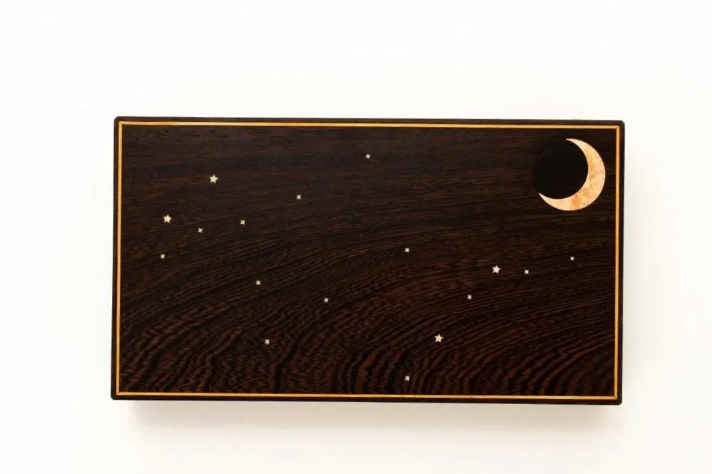 The top features the owner's star sign. The stars are made from crushed sea shell from her favorite beach.