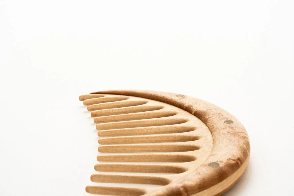 The birdseye maple used on the comb handles is reminiscent of moon craters. Each comb is hand-shaped, making them very tactile, and a pleasure to hold in hand.