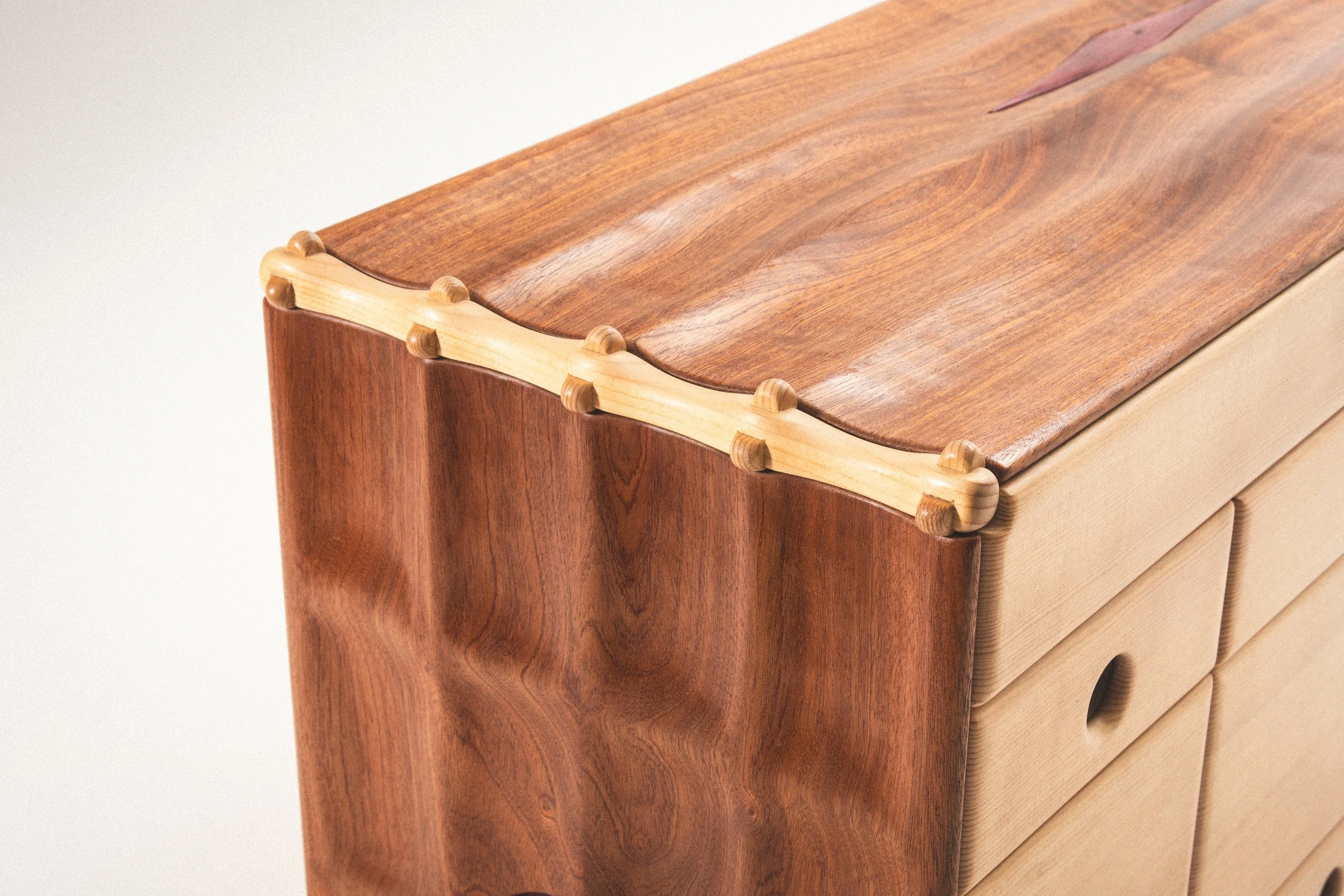 A hand-carved Sapele skin drapes over a Sitka Spruce skeleton.