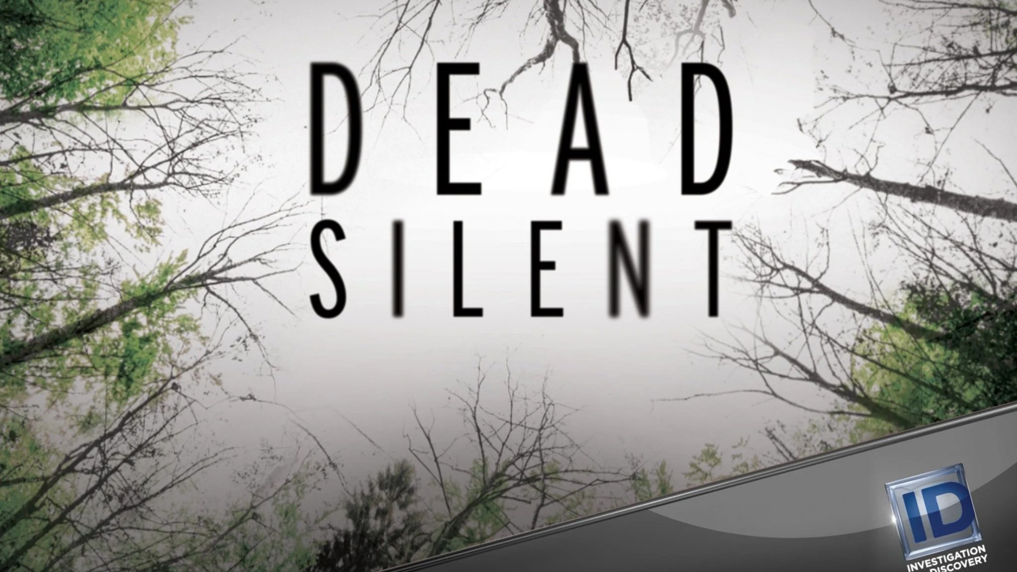 Sign with the words 'Dead Silent' against a background of leafless trees and a cloudy sky.