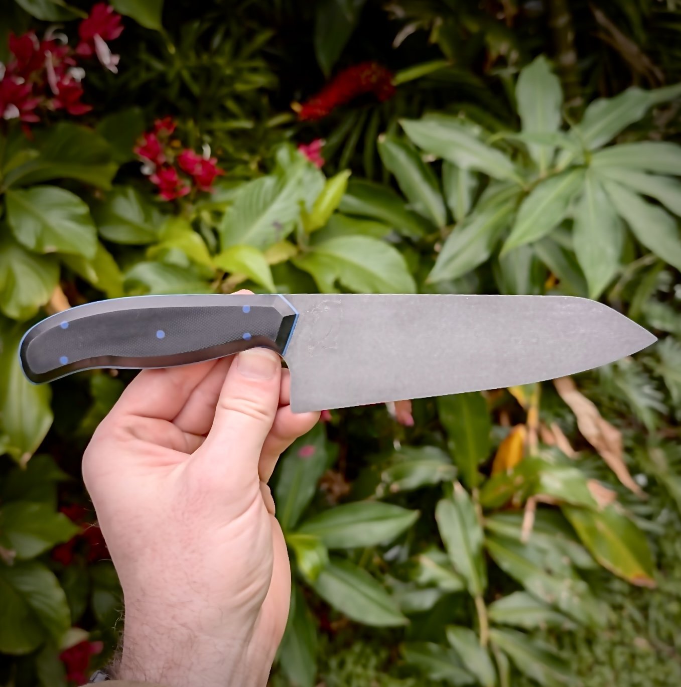 8 inch petty in stone washed, cryo treated 8CR14MOV. Black g10 with blue pins and liner. 